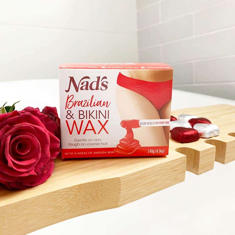 Nad's Brazilian and Bikini Wax product on bathroom counter next to roses and chocolates